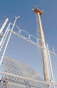 Chain-link border fence with tower