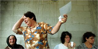 NYT: a woman held a photograph of her brother, who was killed on Sunday by a rocket that hit Haifa