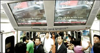 In Seoul, passengers on a subway train watch TV screens broadcasting North Korea's test launches.