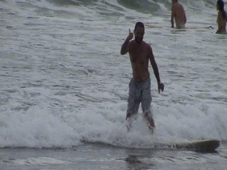 Jason standing up on a surfboard at Kuta Beach