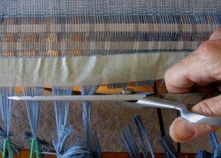 Cutting the knots off the warp.  This took nerve!