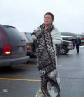 Kid in parking lot wrapped in blanket