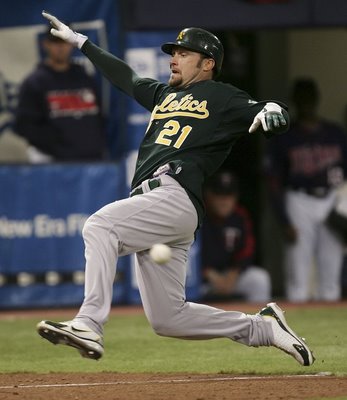 Getty Images photo by Jonathan Daniel: Mark Kotsay beats the throw to home and gets in inside-the-park home run to lift the A's ahead of the Twins 4-2 in the 7th inning of the 2006 ALDS Game 2