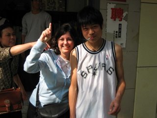 Spurs fan with his mom trying to remove his cigarette for the photo