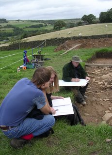 archeologists recording the trench