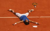 PARIS - JUNE 11: Rafael Nadal of Spain lies on the clay after defeating Roger Federer of Switzerland during the Men's Singles Final on day fifteen of the French Open at Roland Garros on June 11, 2006 in Paris, France. (Photo by Clive Brunskill/Getty Images)