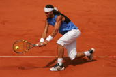 PARIS - JUNE 11: Rafael Nadal of Spain in action against Roger Federer of Switzerland during the Men's Singles Final on day fifteen of the French Open at Roland Garros on June 11, 2006 in Paris, France. (Photo by Matthew Stockman/Getty Images)