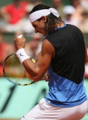 PARIS - JUNE 11: Rafael Nadal of Spain celebrates a point against Roger Federer of Switzerland during the Men's Singles Final on day fifteen of the French Open at Roland Garros on June 11, 2006 in Paris, France. (Photo by Clive Brunskill/Getty Images)