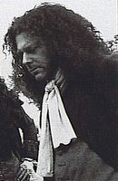 Richard Coyle as Alcock