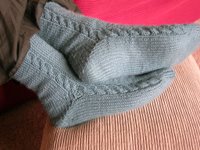 India's feet modelling turquoise cabled socks, Debbie Bliss Cashmerino Baby