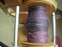 bobbin of dark violet/grey merino/tencel spun singles