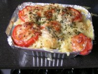 photo of home made macaroni and cheese, topped with tomatoes, parmesan and parsely