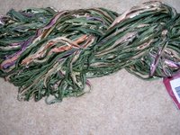 green ribbon yarn with shots of pink, made by Colinette