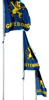 Flags on Kungsports Avenue showing modern city emblem and name, Göteborg.