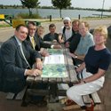 campaigners sit by the lake discussing tactics