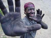 [Pic of Mike Rowe making charcoal.]