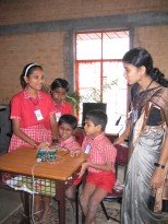 The kids try out the tutor with Vanaja's help.
