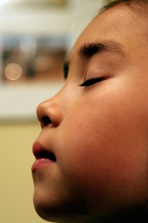 side head shot of beautiful boy with eyes closed, mouth closed, calmly just breathing