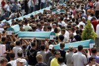 Bosnian people carry coffins of some of the 505 bodies to be buried during funeral ceremony at the Memorial Center Potocari, near Srebrenica north of the Bosnian capital Sarajevo, Tuesday, July 11, 2006. The bodies will be buried marking the 11th anniversary commemorations of the massacre. Serb troops killed over 8,000 Muslim men and boys at Srebrenica in 1995. (AP Photo/Amel Emric)