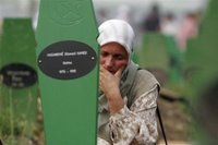 A Bosnian Muslim woman mourns during a funeral ceremony for 505 bodies at the Memorial Center Potocari, near Srebrenica north of the Bosnian capital Sarajevo, Tuesday, July 11, 2006. The bodies will be buried marking the 11th anniversary commemorations of the massacre. Serb troops killed over 8,000 Muslim men and boys at Srebrenica in 1995, and most of the bodies are still missing. (AP Photo/Amel Emric)