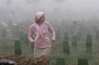 A Bosnian Muslim woman searches for the name of her relative during the funeral ceremony for 505 bodies at the Memorial Center Potocari, near Srebrenica north of the Bosnian capital Sarajevo, Tuesday, July 11, 2006. The bodies will be buried marking the 11th anniversary commemorations of the massacre. Serb troops killed over 8,000 Bosniak men and boys at Srebrenica in 1995. (AP Photo/Amel Emric)