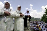 Bosnian Muslim women saying their prayers during the funeral ceremony for 505 bodies at the Memorial Center Potocari, near Srebrenica, north of Bosnian capital Sarajevo, Tuesday, July 11, 2006. The bodies will be buried marking the 11th anniversary commemorations of the massacre where Serb troops killed over 8,000 Bosniak men and boys at Srebrenica in 1995. (AP Photo/Amel Emric)