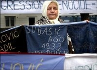 50 Bosnian women, relatives of victims of the Srebrenica massacre gather seen here holding a banner with the 8106 names of the victims in front of the International Court of Justice in The Hague, in February 2006. The United States deported to Bosnia two Bosnian Serbs wanted by a local court on charges of genocide committed in the 1995 Srebrenica massacre, an official said.(AFP/ANP/File/Ilvy Njiokiktjien)