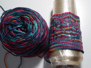 Fleece Artist Merino yarn, colorway Hero, fir cone stitch pattern