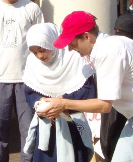 CPT photo of Jim Loney passing a peace dove to a friend for release at a multi-faith walk for the release of Iraqi captives
