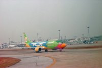 Nok Airlines airplane photo on the tarmac of Bangkok International Airport, a discount airline in Southeast Asia.