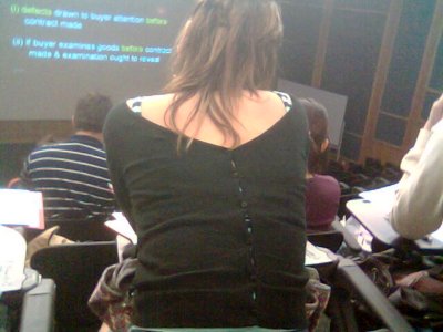 A girl wearing her sweater back to front.