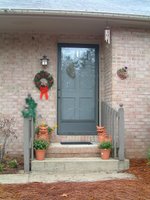 Our front porch during Christmas with the wreath I made right under the porch light.