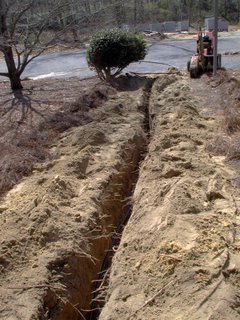 This is what our front yard looked like after we got the trench done and the pipe stretched out but not hooked up yet.