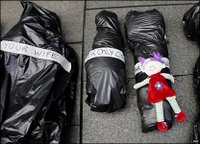 Three of some 300 'body bags' laid out in Sydney's business district in remembrance of civilians killed in recent conflicts across the world