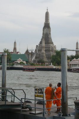 Wat Arun and monks on a pier.