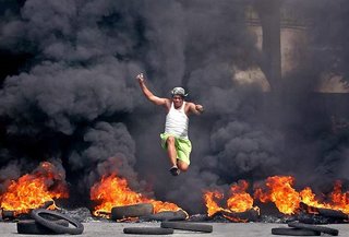 reuters photo - man jump over fire