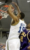 UCLA Ryan Hollins dunks the ball despite the tight defense of LSU forward Tyrus Thomas during the second half of their Final Four semifinal game in Indianapolis. (AP Photos/Darron Cummings)