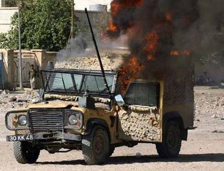 A Snatch Land Rover on fire after an IED attack