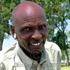 Masai driver Kantim: his ear-lobe wobbled when he went over a bump. Masai Mara, Kenya safari