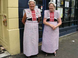 Two women in costume outside restaurant