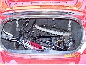 Full size Montague MX folding mountain bike in the trunk of a subcompact