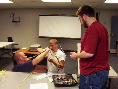 WVUP students Michael Noland, Ted Corbitt and Tim Rapson are shown as they prepared network wiring for the New Orleans Joint Military Operations Center.