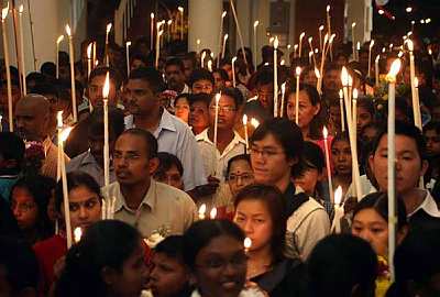  SEA OF LIGHT: Pilgrims holding lighted candles during the procession around the church grounds on Saturday night.