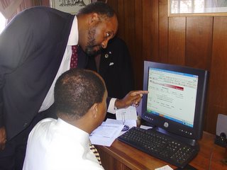 City Administrator Norton Bonaparte and Director of Administration and Finance Ron West review online auction results.