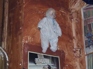 Scary Doll on the wall above Hubby's head