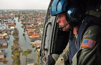 U.S. Coast Guard Petty Officer 2nd Class Shawn Beaty of Long Island, N.Y., looks for survivors in the wake of Hurricane Katrina