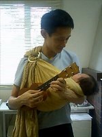 I play baby ukulele keeping my baby in a baby sling