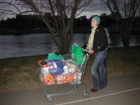 Jessica pushing our shopping trolley full of groceries up the path toward the dorms after crossing the bridge over Lake Ginninderra.