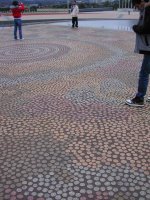 This is an aboriginal work made out of various colored stones that represent the people of Australia coming to one meeting place.