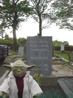 Photographer unknown: a Yoda figurine stands in front of W.B. Yeats's gravestone